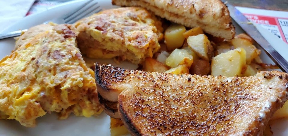 Diner menu featuring omelets and sandwiches.